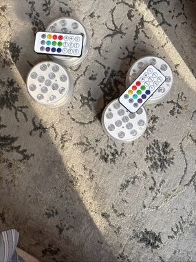 4 puck LED lights w 2 remotes